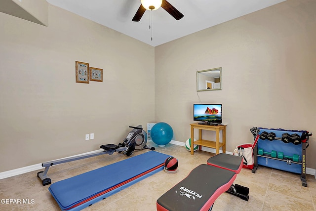 exercise room with a ceiling fan and baseboards