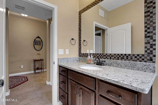 bathroom featuring vanity, visible vents, and baseboards