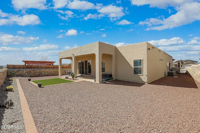 rear view of property with a patio, central air condition unit, stucco siding, a pergola, and a fenced backyard