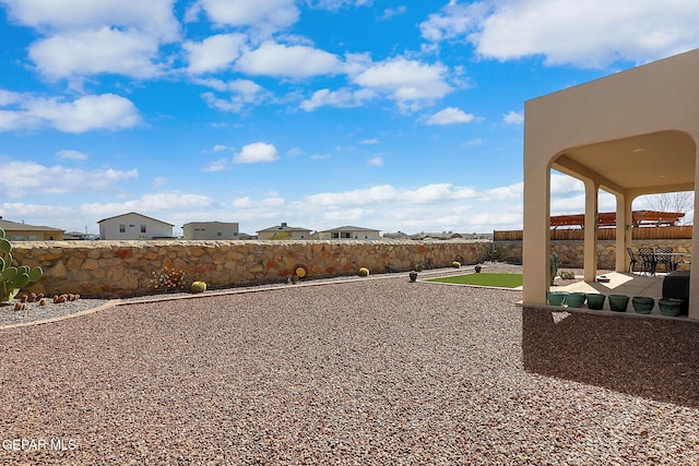 view of yard featuring a patio area and a fenced backyard