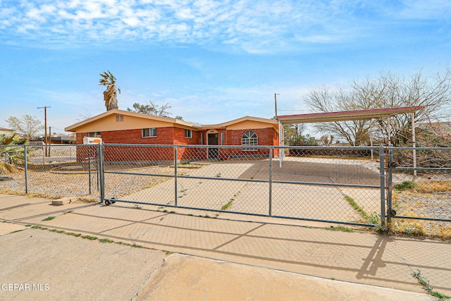 view of front of property featuring a fenced front yard, a gate, and brick siding