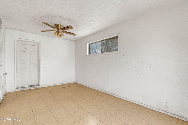 spare room featuring a textured ceiling and a ceiling fan