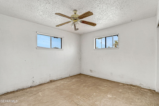 empty room featuring ceiling fan and a textured ceiling