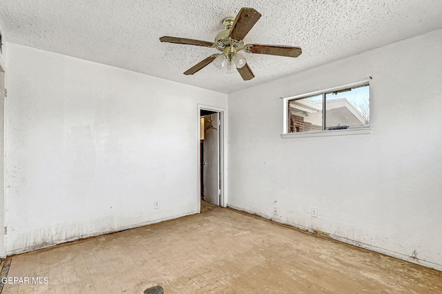 unfurnished room featuring ceiling fan, a textured ceiling, and wood finished floors