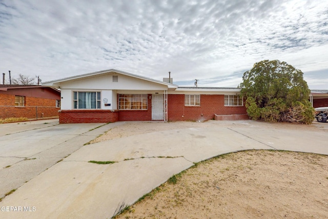 single story home featuring brick siding