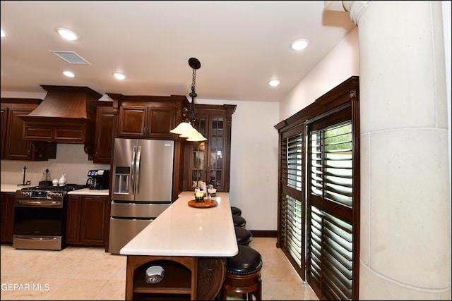 kitchen featuring custom exhaust hood, light countertops, visible vents, appliances with stainless steel finishes, and dark brown cabinets