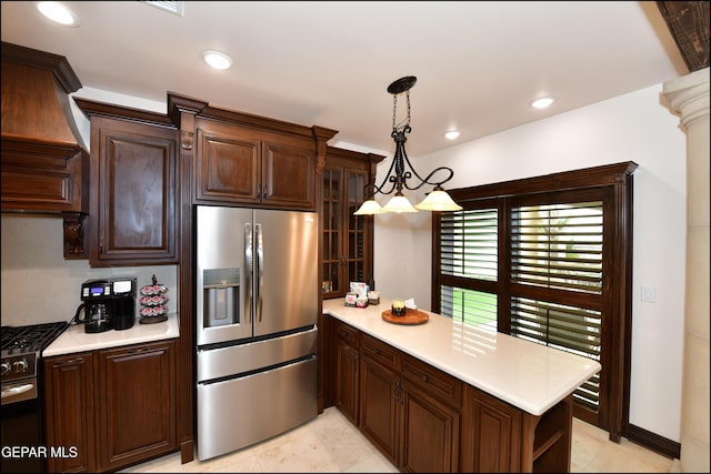 kitchen with dark brown cabinetry, stainless steel appliances, and light countertops