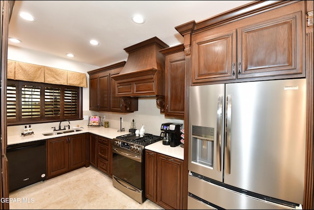 kitchen featuring recessed lighting, light countertops, custom range hood, appliances with stainless steel finishes, and a sink