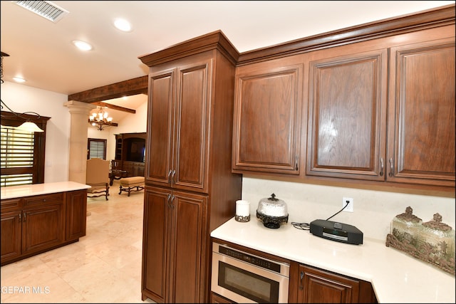 kitchen featuring visible vents, an inviting chandelier, light countertops, ornate columns, and recessed lighting