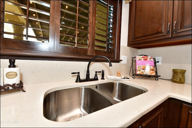 kitchen with dark brown cabinets and a sink