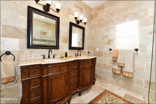 bathroom featuring double vanity, backsplash, a sink, and tile walls