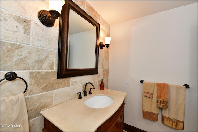 bathroom featuring backsplash, vanity, and tile walls