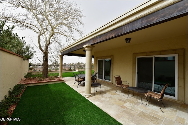 view of patio featuring fence