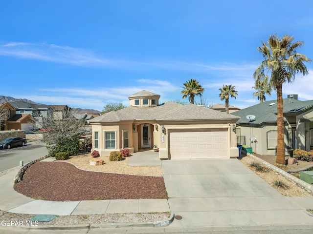 view of front facade featuring a garage, concrete driveway, a shingled roof, and stucco siding