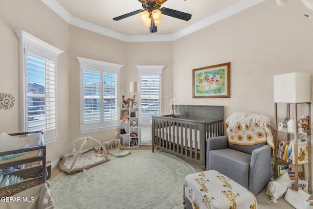 bedroom with carpet flooring, a ceiling fan, and crown molding