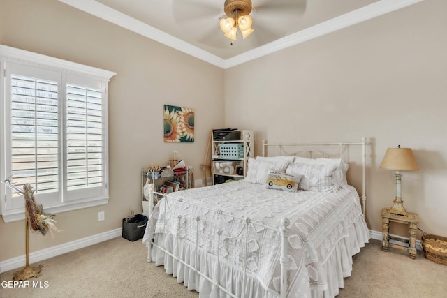 bedroom with a ceiling fan, baseboards, ornamental molding, and carpet flooring