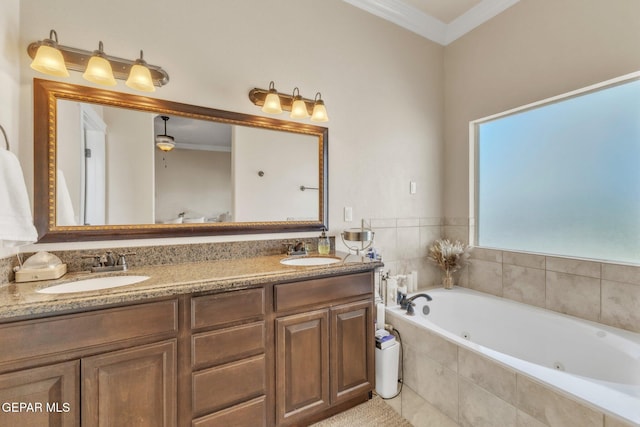 bathroom with crown molding, a sink, a jetted tub, and double vanity