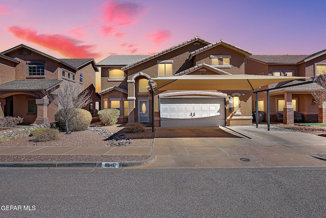 view of property with driveway, an attached garage, and stucco siding