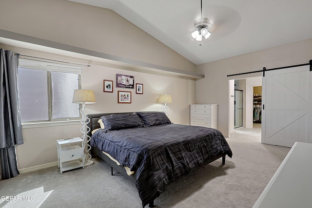 carpeted bedroom with lofted ceiling, ceiling fan, a barn door, and baseboards