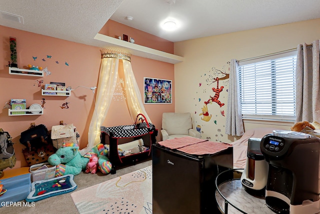 carpeted bedroom featuring a textured ceiling