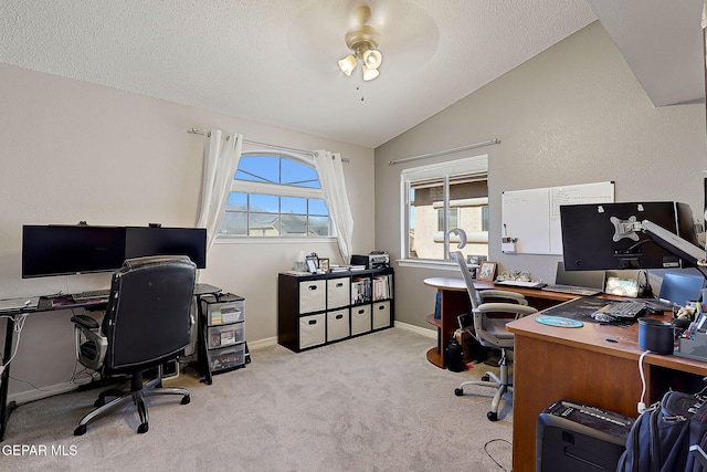 carpeted home office with lofted ceiling, ceiling fan, baseboards, and a textured ceiling