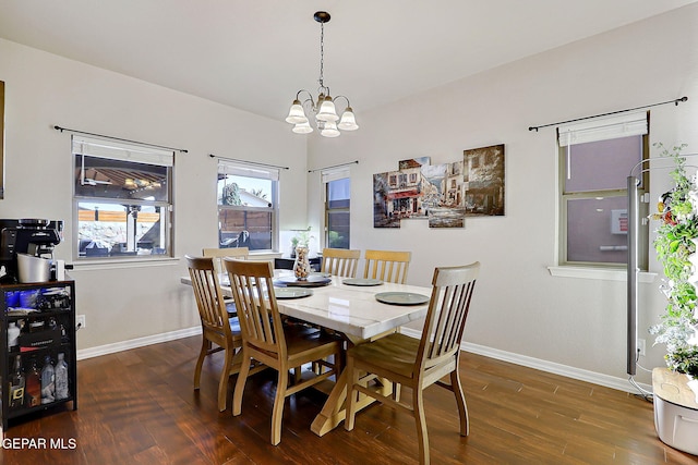 dining area with a chandelier, baseboards, and wood finished floors