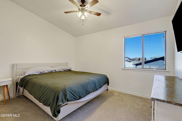 bedroom featuring light carpet, baseboards, a ceiling fan, and lofted ceiling