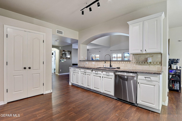 kitchen featuring dark wood-style flooring, tasteful backsplash, stainless steel dishwasher, white cabinetry, and a sink