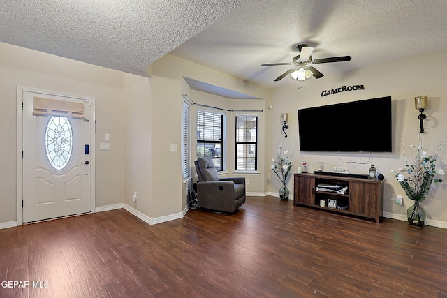 foyer with ceiling fan, wood finished floors, a wealth of natural light, and baseboards