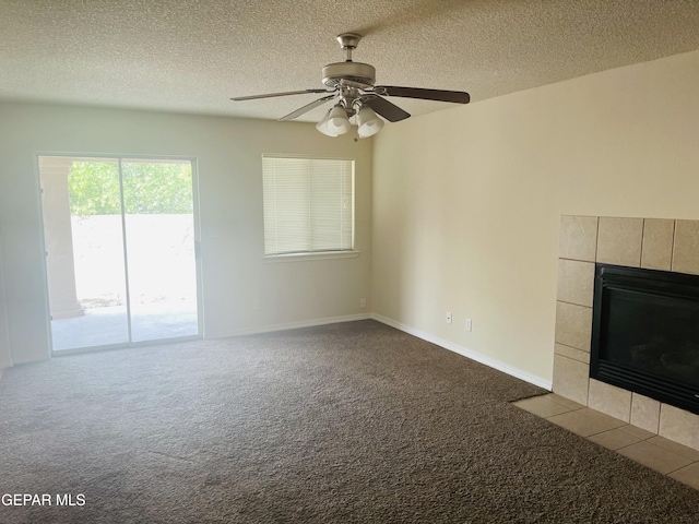 1513 Prickley Pear Dr, El Paso, TX 79912 - unfurnished living room with a tile fireplace, carpet floors, ceiling fan, and a textured ceiling