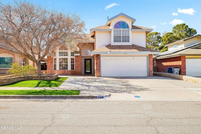 traditional-style house featuring a garage, concrete driveway, and brick siding