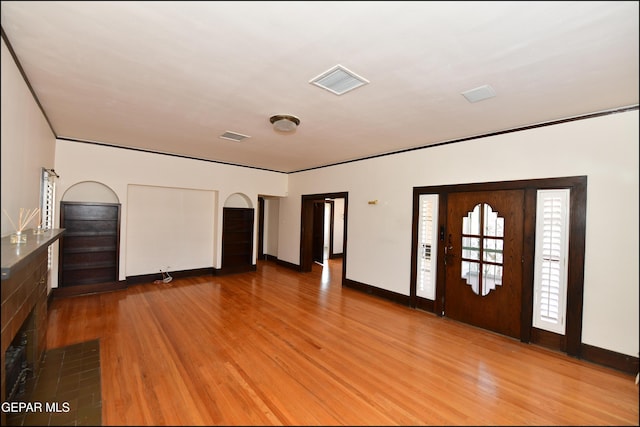 interior space featuring baseboards, visible vents, and wood finished floors