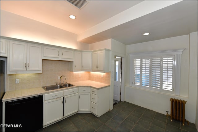 kitchen featuring tasteful backsplash, visible vents, dishwasher, radiator heating unit, and a sink