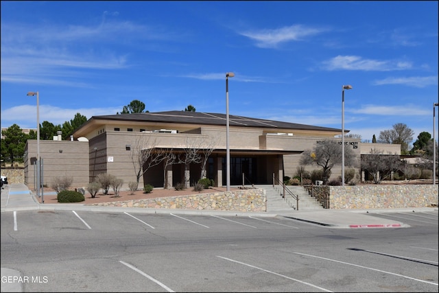 view of property featuring uncovered parking