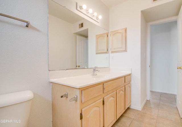 bathroom featuring visible vents, toilet, tile patterned flooring, baseboards, and vanity