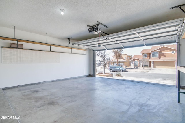 garage with baseboards and a garage door opener