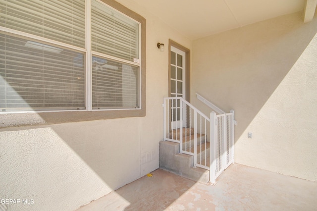 doorway to property featuring stucco siding