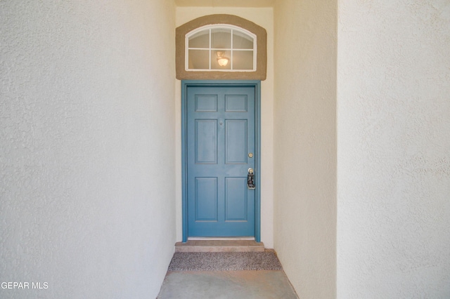 property entrance with stucco siding