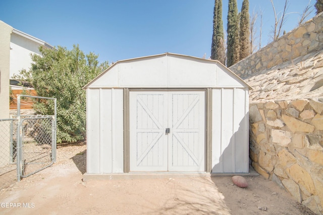 view of shed with a gate and fence