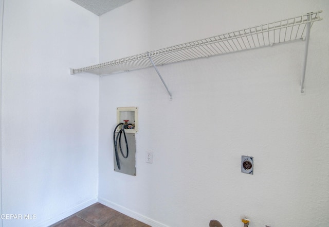 washroom with electric dryer hookup, baseboards, gas dryer hookup, hookup for a washing machine, and laundry area