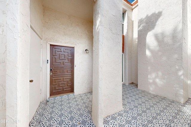 doorway to property featuring stucco siding