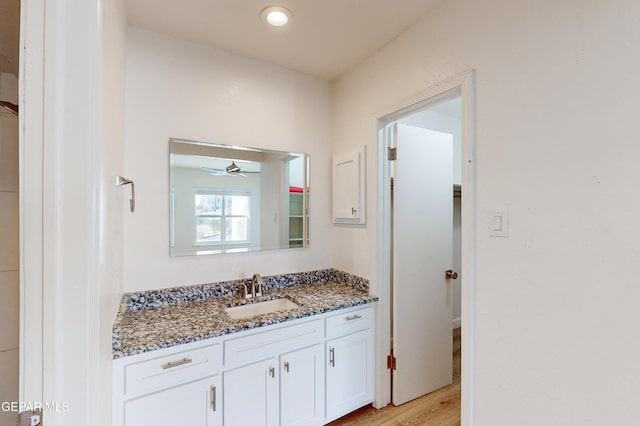 bathroom featuring vanity, wood finished floors, and a ceiling fan