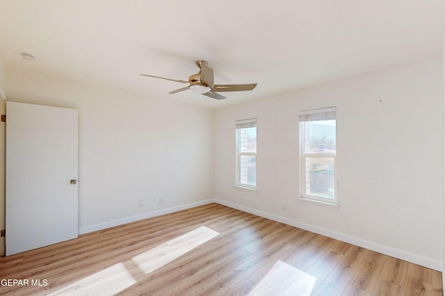 empty room with ceiling fan, baseboards, and light wood-style floors