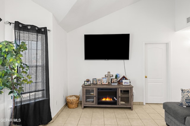 living area featuring visible vents, baseboards, vaulted ceiling, and light tile patterned flooring