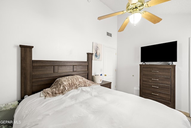 bedroom with ceiling fan, high vaulted ceiling, and visible vents