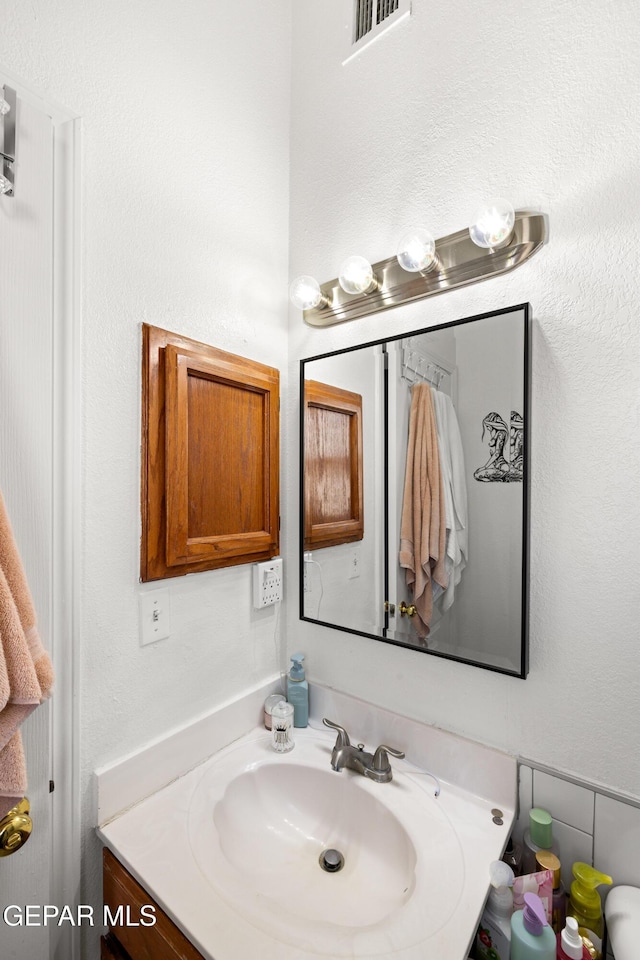 bathroom featuring vanity and visible vents