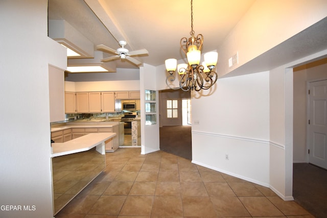 kitchen featuring decorative light fixtures, light tile patterned floors, visible vents, light countertops, and stainless steel microwave