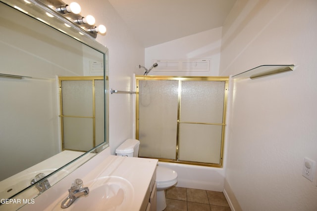 bathroom featuring bath / shower combo with glass door, lofted ceiling, toilet, vanity, and tile patterned floors