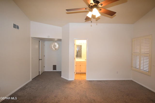 unfurnished bedroom featuring a ceiling fan, visible vents, baseboards, carpet, and ensuite bath