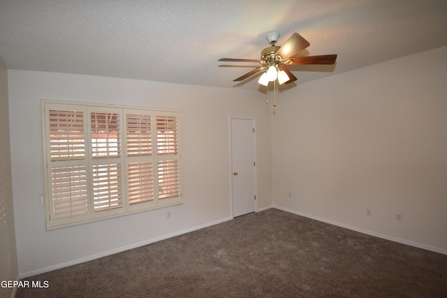 carpeted spare room with a textured ceiling, ceiling fan, and baseboards